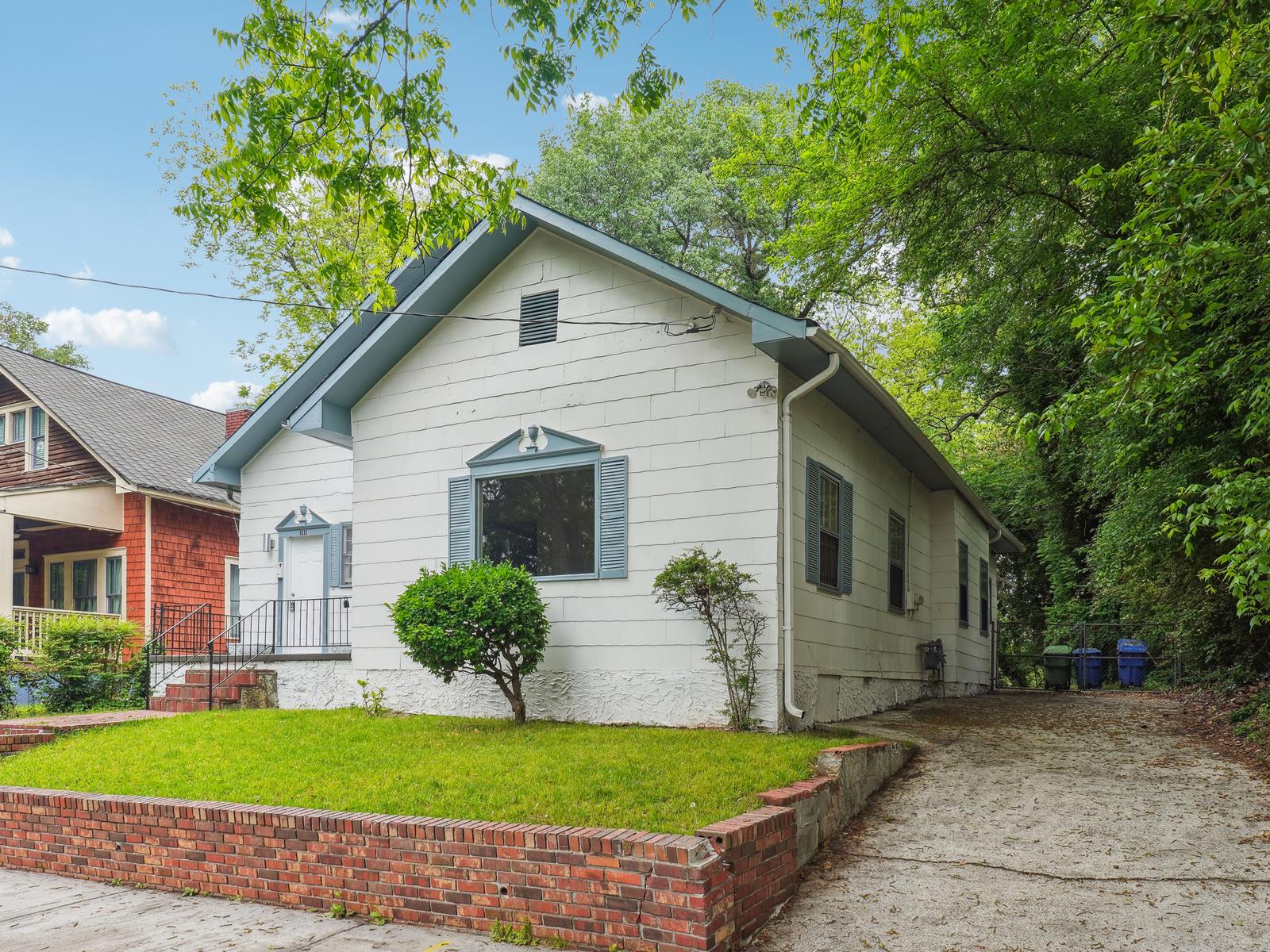 Renovated home exterior with fresh paint, clean landscaping, and restored curb appeal